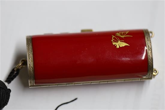 A ladys 1920s silver gilt and gilded red enamelled ovoid minaudiere, import marks for Cohen & Charles, London, 1925, 82mm.